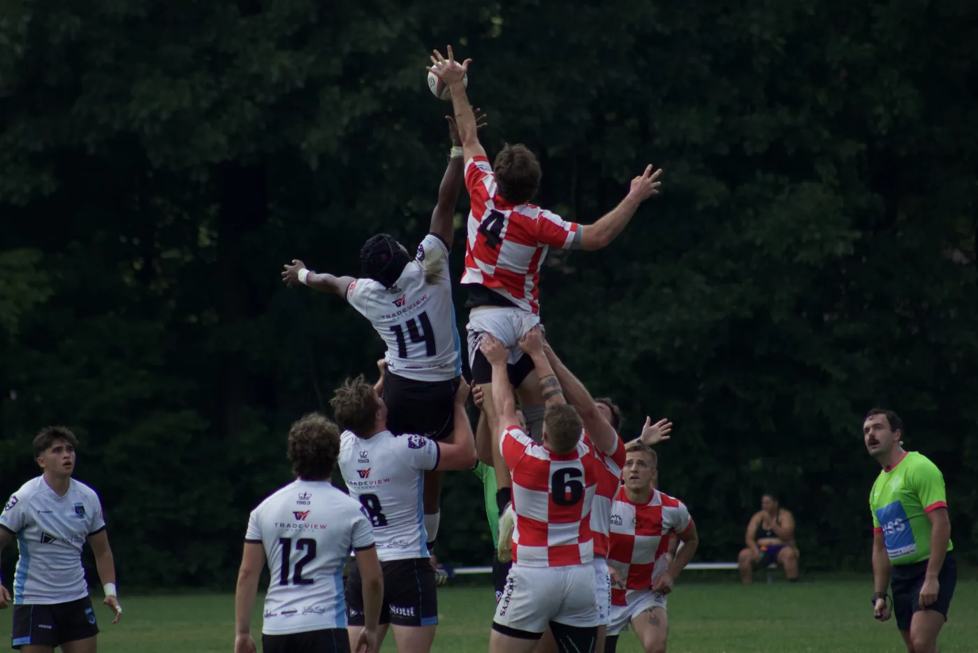 Rugby lineout — player rises above the pack to claim the ball