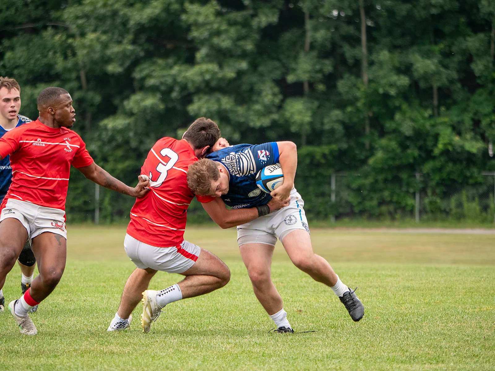 Ball carrier wrapped up by two defenders in the tackle — men's club